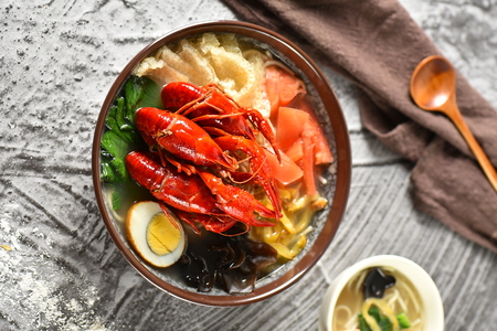 A bowl of crawfish noodles with eggの写真素材