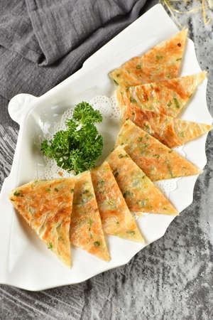A plate of ried hand made scallion pancakesの写真素材