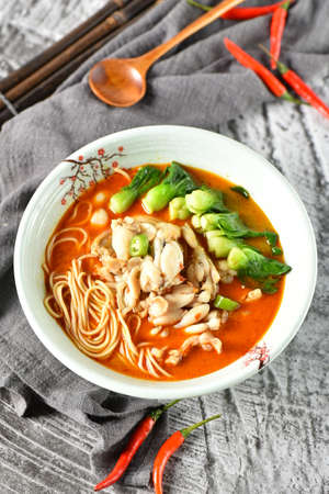 A bowl of spicy red oil bullfrog noodlesの写真素材