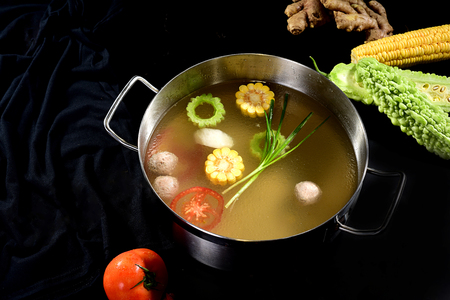 Tomato soup hot pot with fresh vegetablesの写真素材