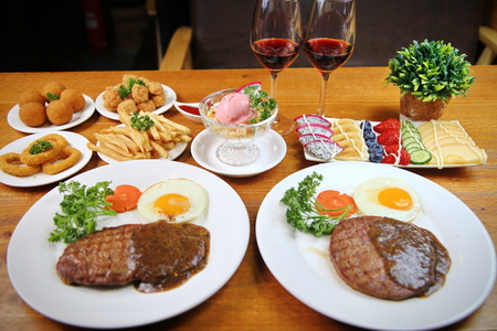 A two man steak dinner with side dishesの写真素材
