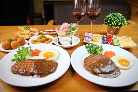 A two man steak dinner with side dishesの写真素材