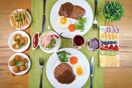 A two man steak dinner with side dishesの写真素材