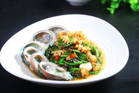 Fried abalone with green pepper and basilの写真素材