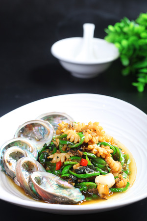 Fried abalone with green pepper and basilの写真素材