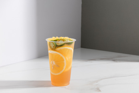 Peach orange tea in a transparent glassの写真素材