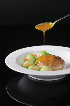 Large meatball with crab meat in a white dish