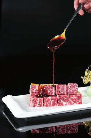 Angus beef cubes on a white dish