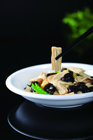 Fresh tofu skin and fungus in a white dishの写真素材