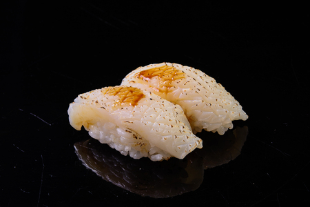 Toasted squid sushi in the black backgroundの写真素材