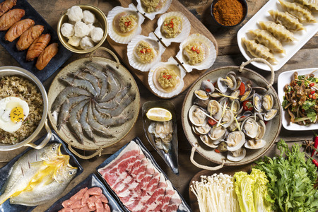 The table is filled with fresh seafoodの写真素材