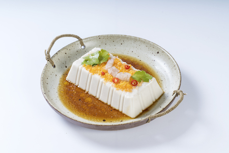 Crab roe tofu with soy sauce in a ceramic dishの写真素材
