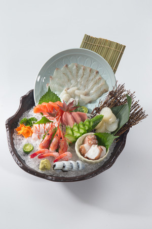 Japanese sashimi with ice in a ceramic potの写真素材