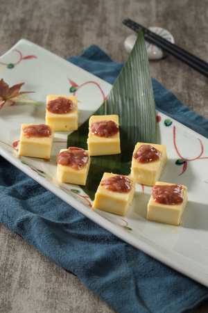 Japanese cuisine with cheese in a ceramic dish