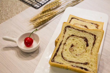 Red bean and mashed potato toast on a piece of white tablecloth