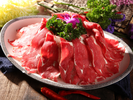 Sliced fresh beef in a white dishの写真素材