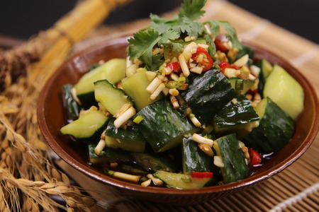 Spicy cold cucumber in sauce in a ceramic dishの写真素材