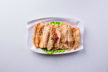 Fresh honeycomb tripe in a white ceramic dishの写真素材