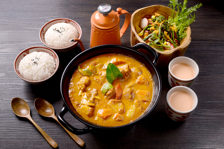 Thai curry chicken in a black ceramic pot and rice set mealの写真素材