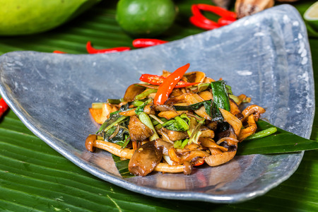 Malacca fried wild fungus in a blue ceramic dishの写真素材