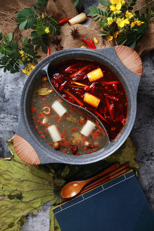 Spicy red oil and clean soup hotpot in a ceramic pot