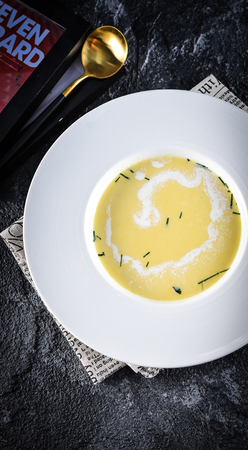 Creamy corn soup in a white ceramic dishの写真素材