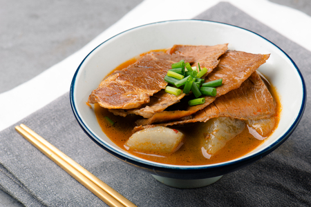Braise  meat with soy sauce in a white ceramic dishの写真素材
