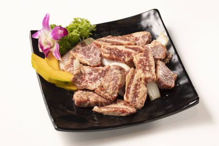 Fresh cut barbecue seasoning meat in a black ceramic dishの写真素材