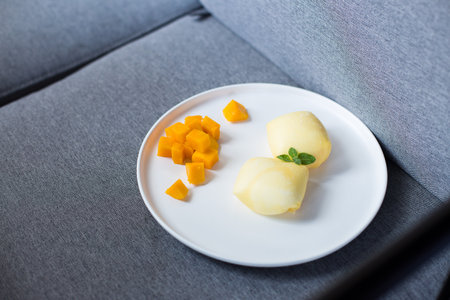 Mango dessert cakes in a white ceramic dish