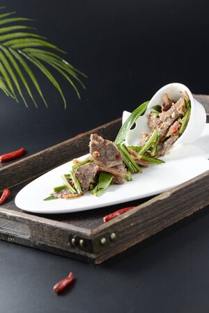 Cold wild cilantro with sliced beef in a white ceramic dishの写真素材