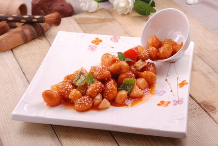 Pineapple sweet and sour in a white ceramic dishの写真素材