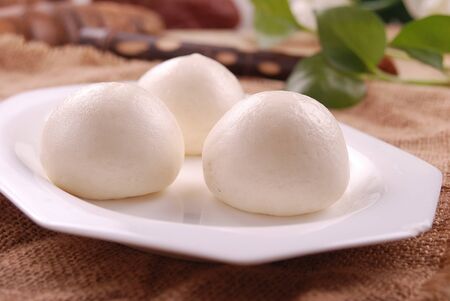 Lard steamed creamy custard bun in a white ceramic dishの写真素材