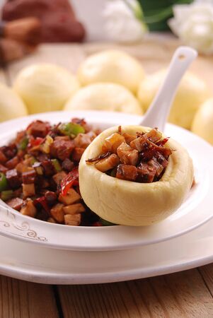 Multigrain bun with meat in a white ceramic dishの写真素材