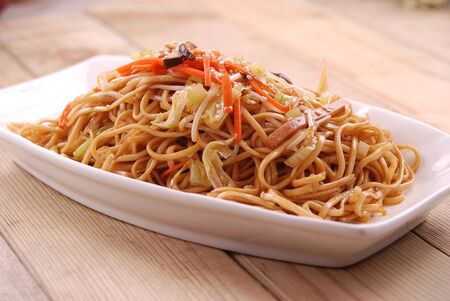 Fried noodles with three shredded ingredients in a white ceramic dishの写真素材