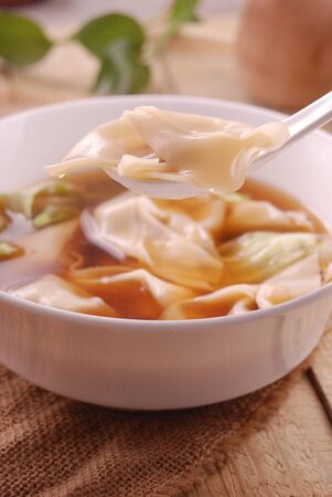 Sichuan wanton soup in a white ceramic dishの写真素材