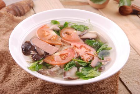 Three fresh delicacies soup in a white ceramic dishの写真素材