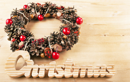 Christmas frame for greeting card with decorative wreath. wooden backgroundの写真素材
