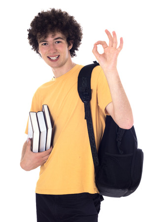 Smiling happy student standing with backpack and books and showing ok sign. Isolated on white.の写真素材