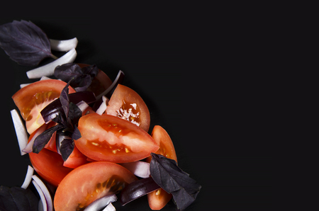 Slices of tomato.  Vegetables on Black background with copy spaceの写真素材