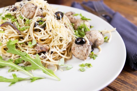 Pasta and meatballs with anchovies and olives. Top viewの写真素材