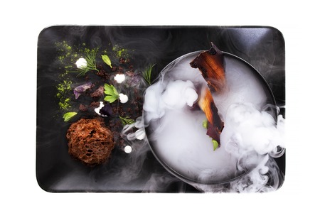 Culinary abstraction. Molecular Cuisine. Delicious modern soup with beetroot. Isolated on white. Stock image.の写真素材