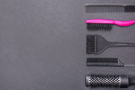 Salon Hairdresser Accessories, pink Comb, application brush, 
brashing for cutting hair or colored on a black backgroundの写真素材