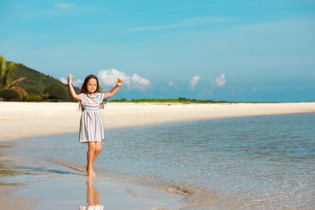 Adorable little girl have fun on the beachの写真素材