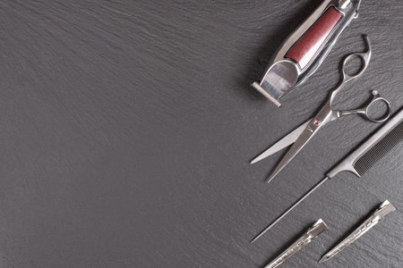 Stylish Professional tool, Hair Cutting on black background. Hairdresser salon concept, Copy space...