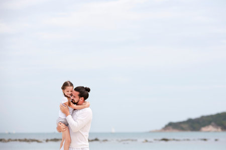 Father and daughter walking on deserted tropical beach. happy loving vacation