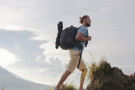 Hiker man with backpack enjoy with volcano Batur, Indonesiaの写真素材
