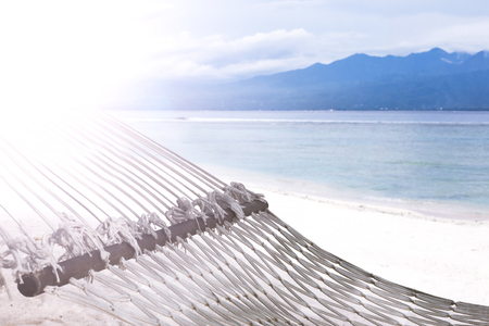 Hammock on sandy beach on background of azure Bali Sea. Coast of the Gili Trawangan island, Indonesia.の写真素材