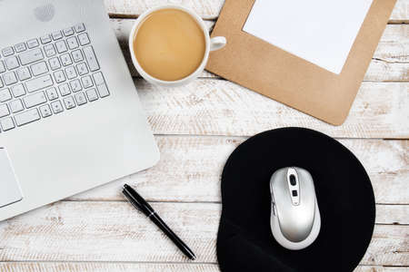 Coffee table with laptop and notebookの写真素材