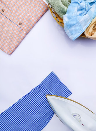 Ironing flatlay with iron box and shirtsの写真素材
