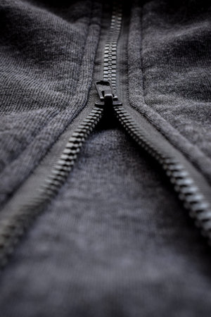 Close up view of woolen sweater cloth with vintage metal button